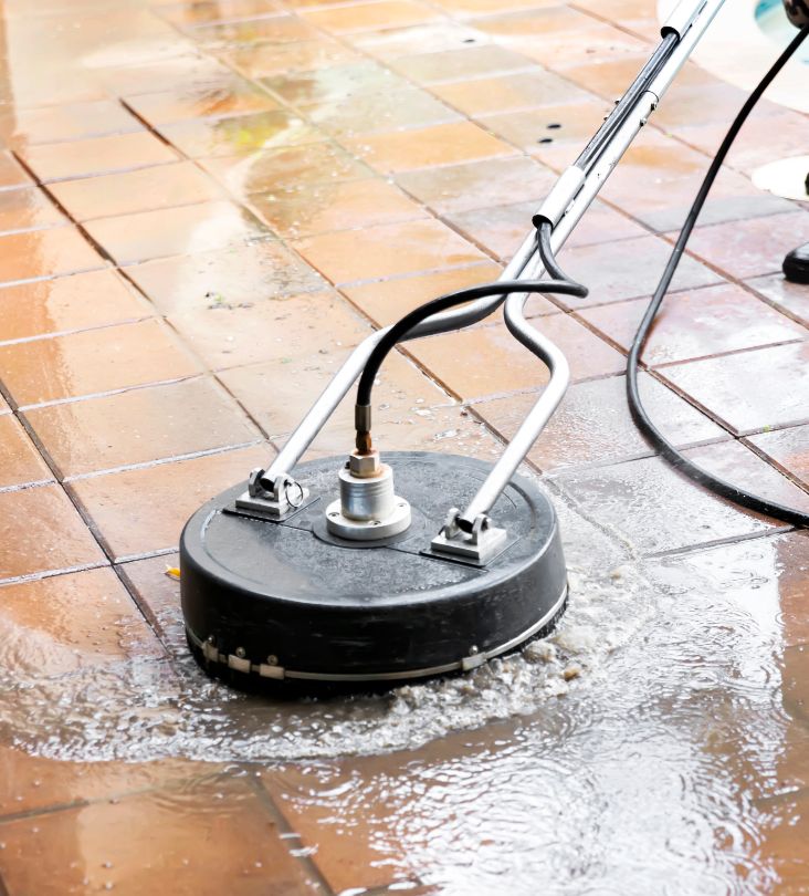 power washing machine is being used in cleaning the patio tiles around pool chesapeake va